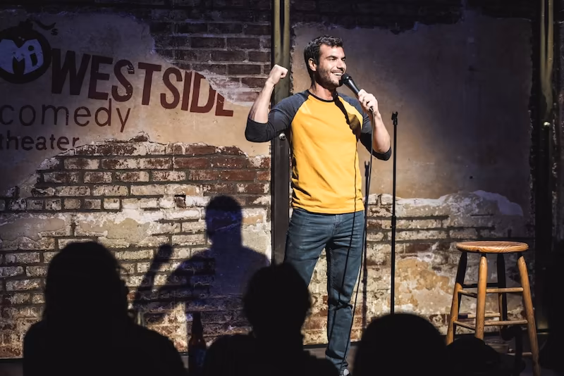 Stand-Up Comedy Class Stand-up comedian holding a mic